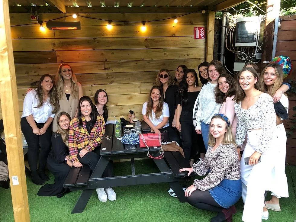 Women socialising at an outdoor picnic table