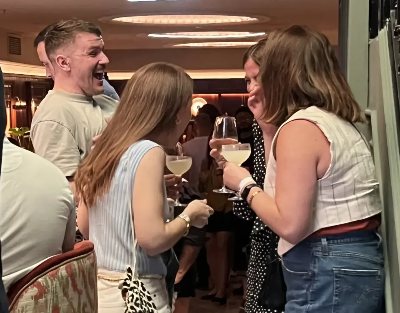 Guests chatting and enjoying drinks at a hosted singles event